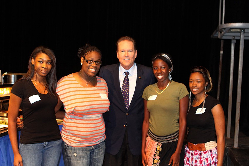 Booker High School Key Club members Janae Bryant, 17, Venesha Bryant, 18, Sandi Jackson, 18, and Akira Peterson, 18, pose with Congressman Vern Buchanan, Friday, April 20, at the Golden Apple Dinner Theater.