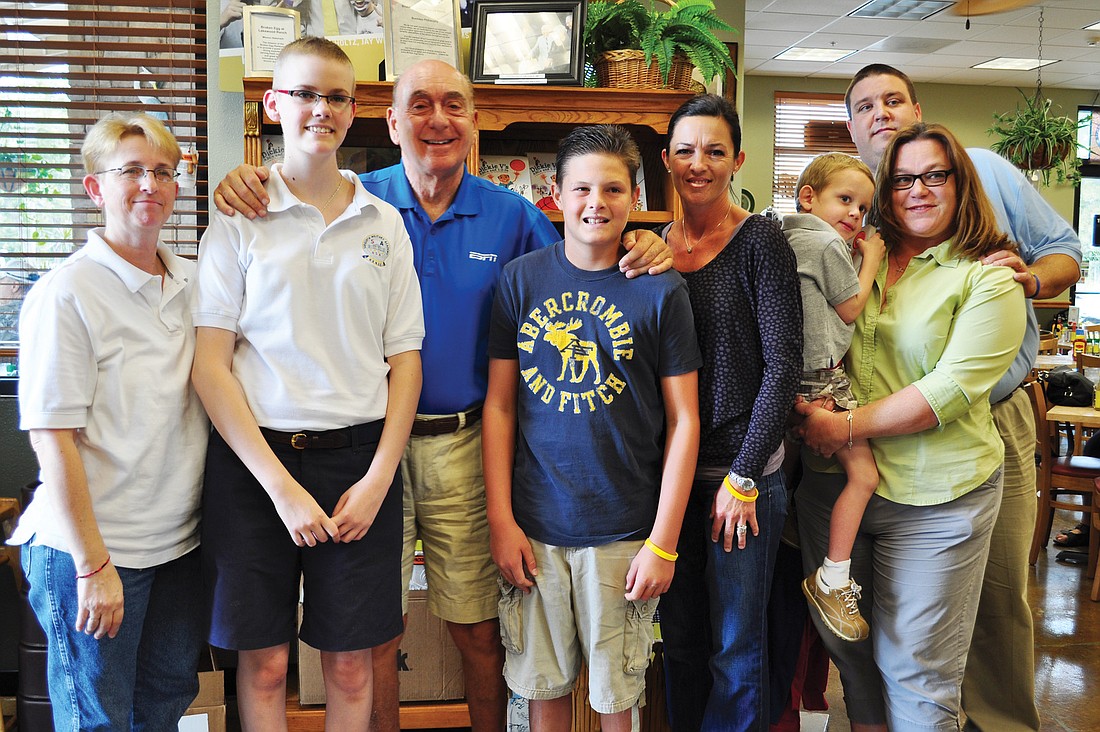ESPN commentator Dick Vitale will recognize three area families at his upcoming gala to raise $1 million for cancer research. From left: Pat Myers, Ashley Krueger, Vitale, Kyle and Jennifer Peters and Eddie, Craig and Jeanine Livingston.