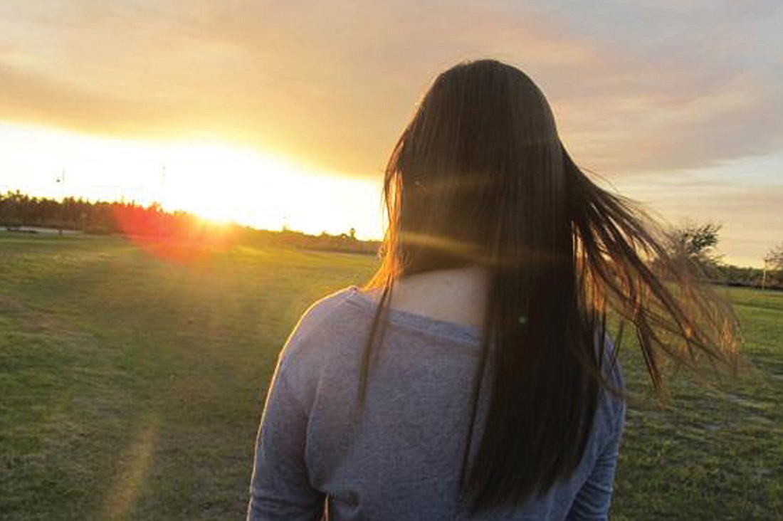 Michelle Vanderford took this photo of her friend, Ashlynn, at sunset during a service at Bayside Community Church.