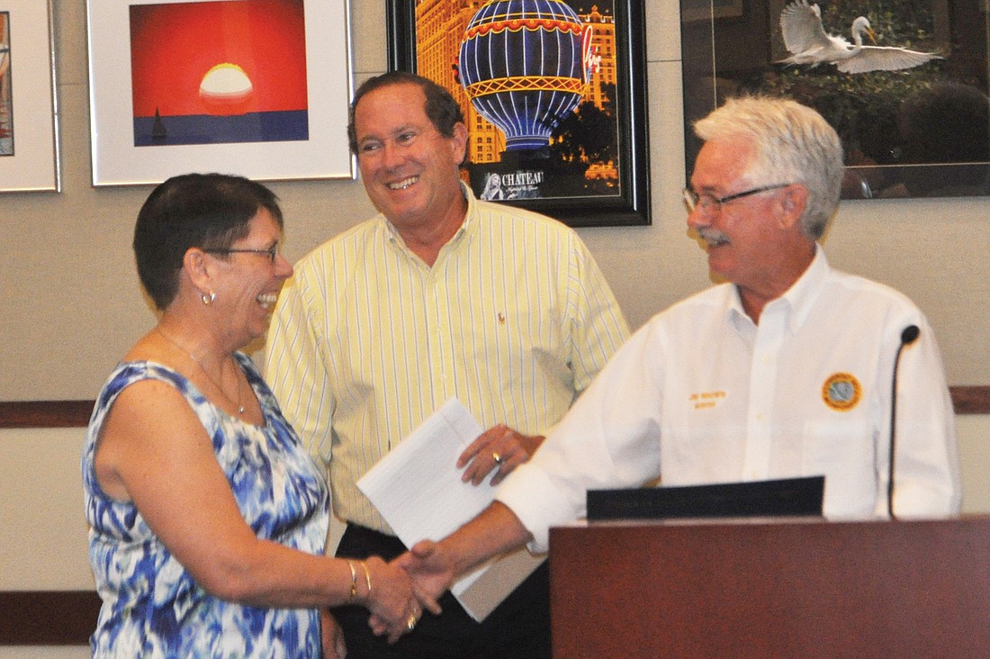 Finance Director Tom Kelley and Mayor Jim Brown thank Sandy Moutoux for her service to the town.