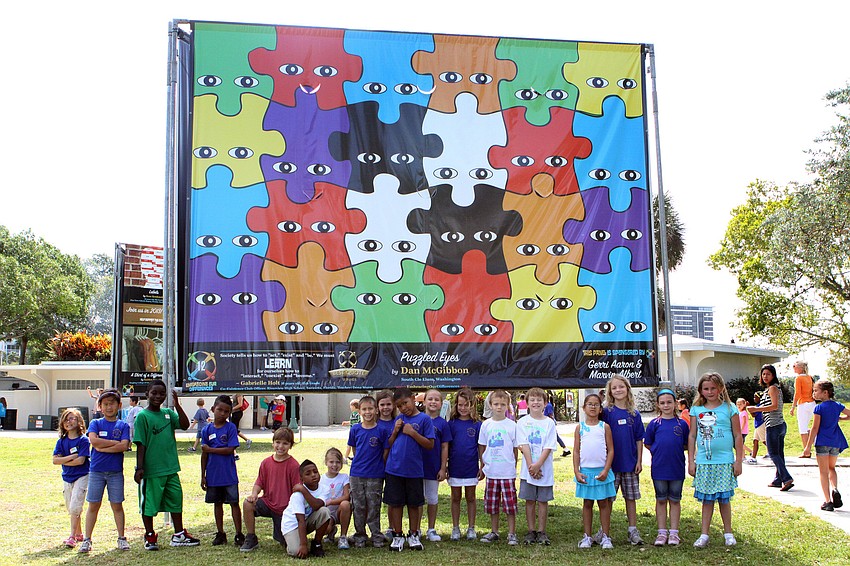 Mrs. Boydâ€™s class from Bayhaven Elementary School pose in front of â€œPuzzled Eyesâ€ by Dan McGibbon, Friday, April 20.