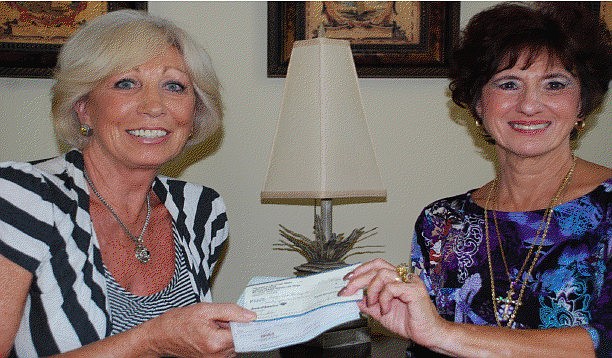 Susan Ford, President of Sarasota British Club, presents check to Sharon Leber, founder of Hope in a Backpack.