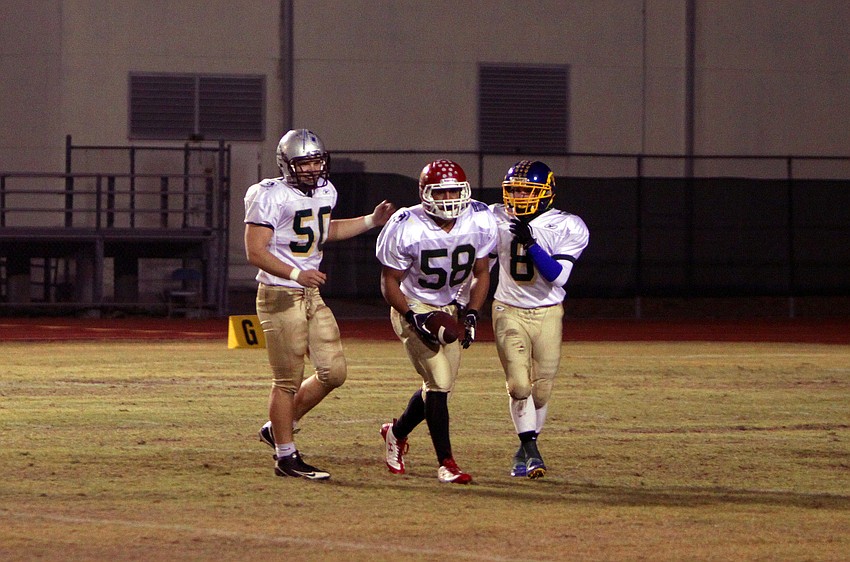 Nathan Kirkman, 50, Hershel Caywood, 58, and Josh Maugherman, 8, celebrate a good play during the 20th Annual Brad Price Memorial PAL Bowl.