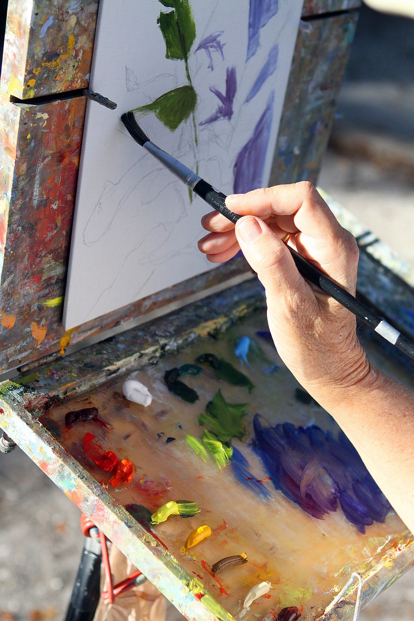 Terry Mason works on her painting, Thursday, Jan. 12, at Towles Court along with the other Plein Air Sun Coast artists.
