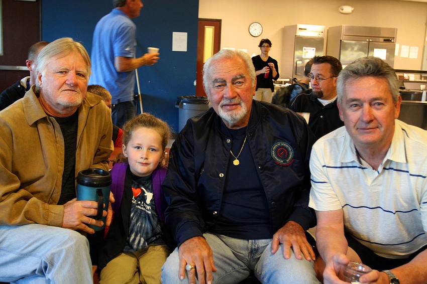 Deianeira McClain, 4, enjoyed having donuts with her grandfathers Gary Overstreet, and Johnny Aquilino along with her dad, Doug, Friday, Jan. 13, at Imagine School's 