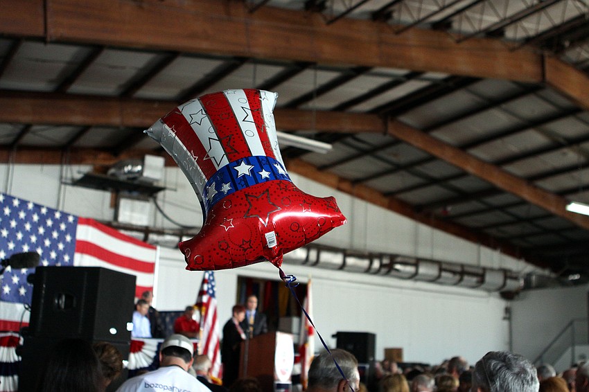 A red, white and blue hat balloon waves around during the Newt Gingrich rally at Dolphin Aviation.