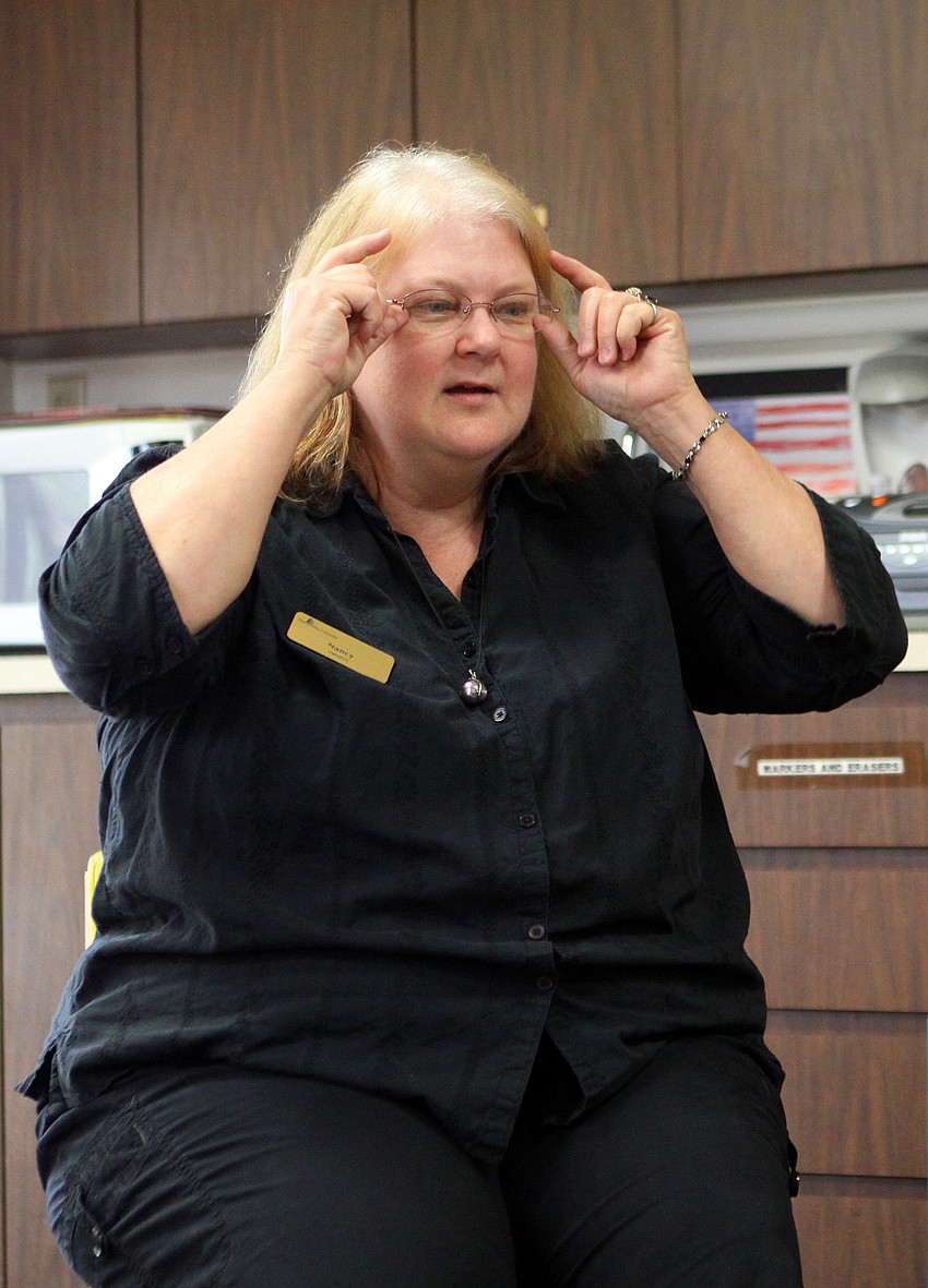 Youth librarian Nancy Velazquez does the sign for â€œwake upâ€.