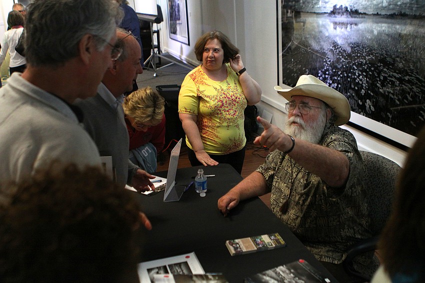 Clyde Butcher talks to people after his presentation.