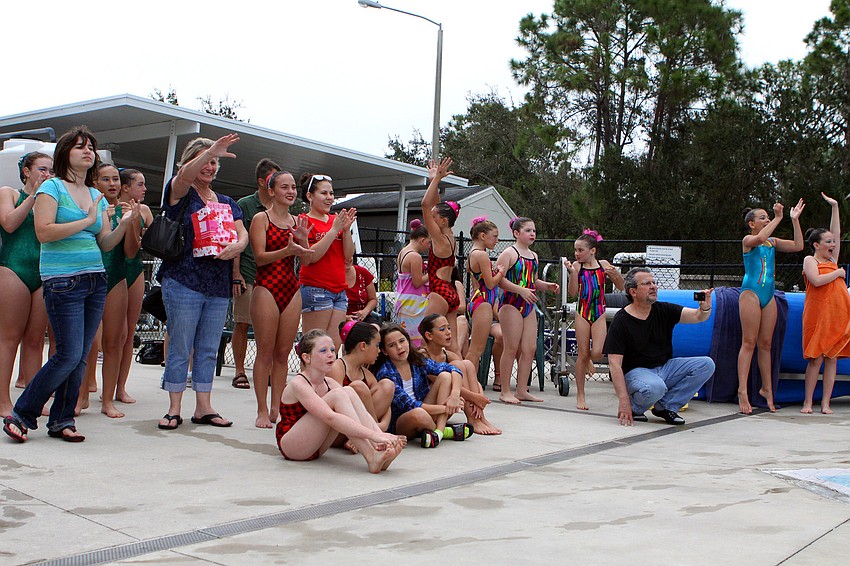 Parents and teammates cheer for one of the girls during a solo performance, Sunday, Feb. 19.