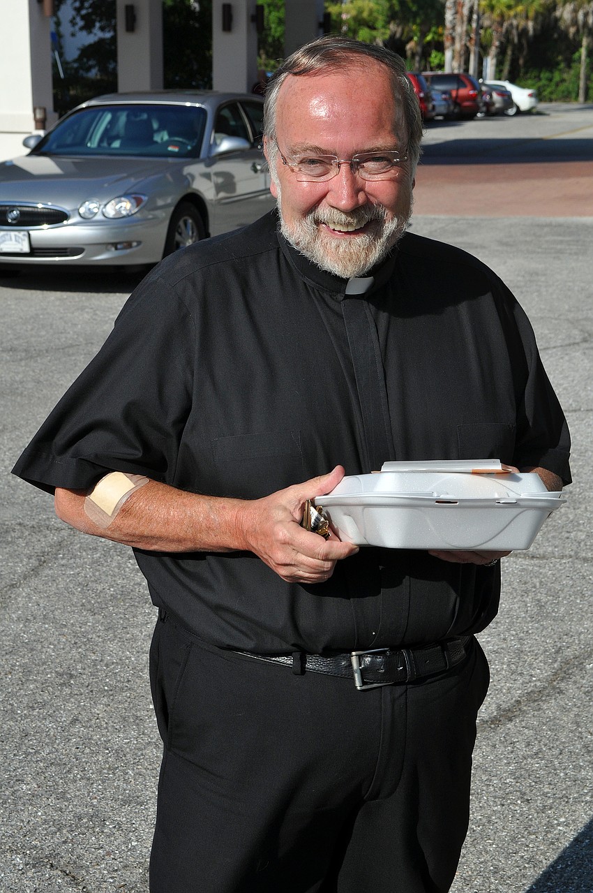 Fr. Joe Stearns takes his Lent dinner to go, Friday, March 23, at St. Michael the Archangel.
