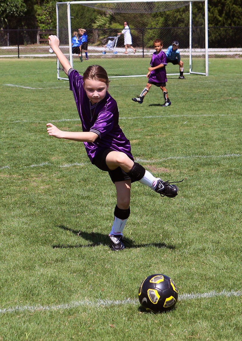 Ella Middleton, 9, kicks the ball.