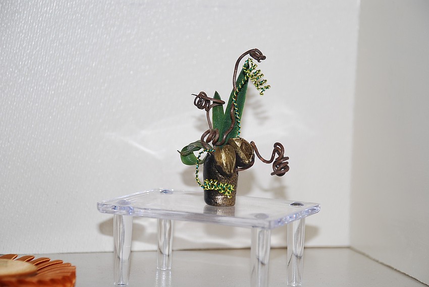 Clare Milligan won Best Design of Excellence out of 48 designs and first place in her group â€œPetiteâ€. The arrangements could not be more than three inches tall