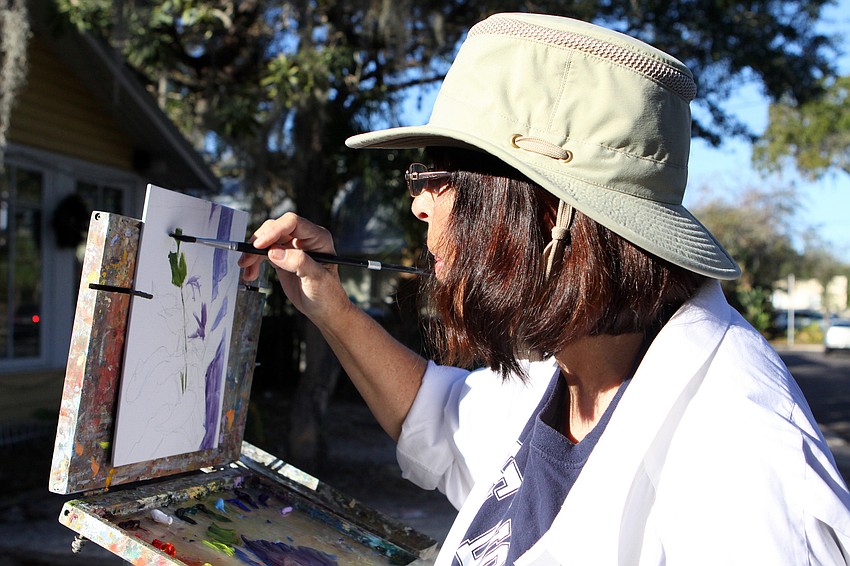 Terry Mason works on her painting, Thursday, Jan. 12, at Towles Court along with the other Plein Air Sun Coast artists.