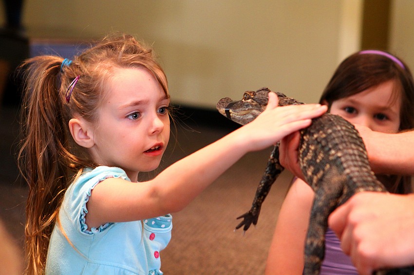 Linda Hayes pets Tinkerbell, Thursday, Jan. 12, inside the Parish Hall at St. Boniface.