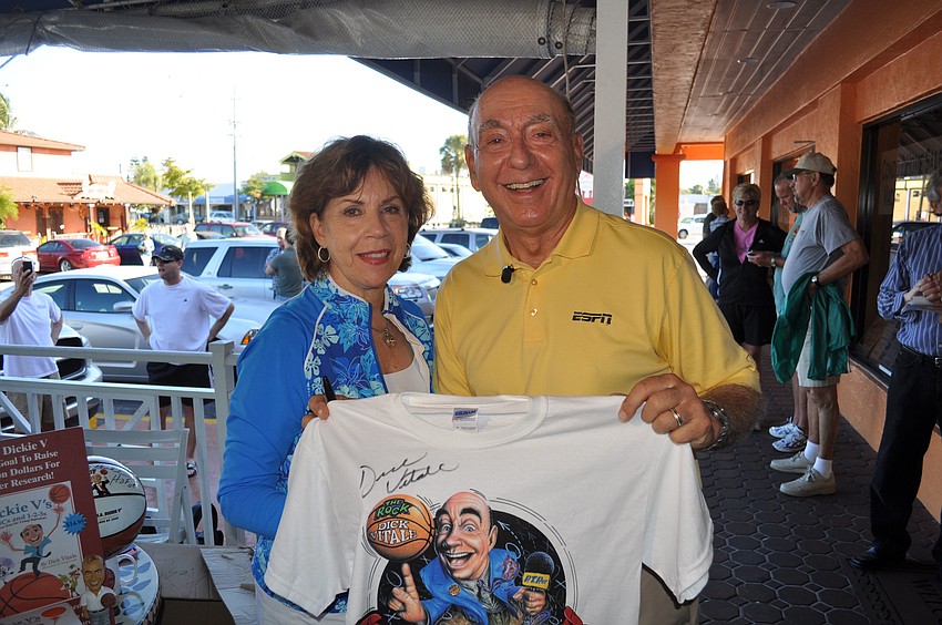 Lorraine and Dick Vitale pose with one of his autographed shirts.