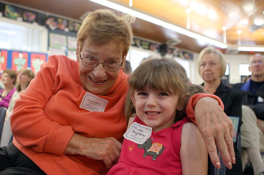 Georgia and Trinity Dougherty sit together as they wait to watch Trinityâ€™s sister, Brogan, perform.