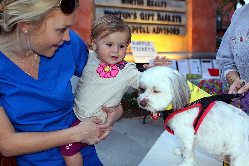 Kristen Shepherd holds Halayna Lynn, 14 mos., while Lynn pets Kaddy, Friday, Feb. 10.
