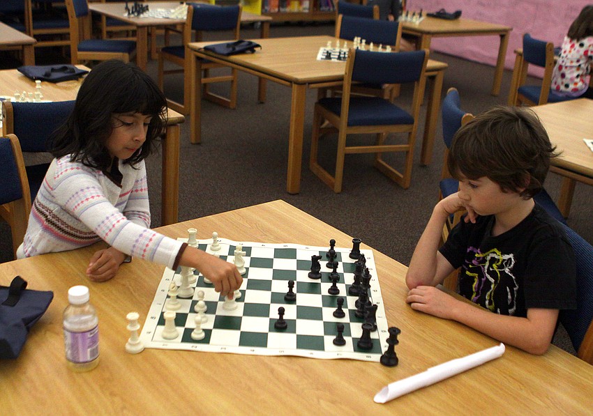 Frida Salinas-Herrera makes a move during her game against Jonathan Witte, Saturday, Feb. 11, in the library at Phillippi Shores Elementary.