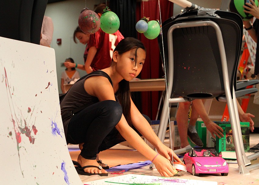 Grace Menke, 10, sets up her group's, â€œEpicly Easyâ€, Rube Goldberg project, Thursday, Feb. 16, during Science Night at Southside Elementary.