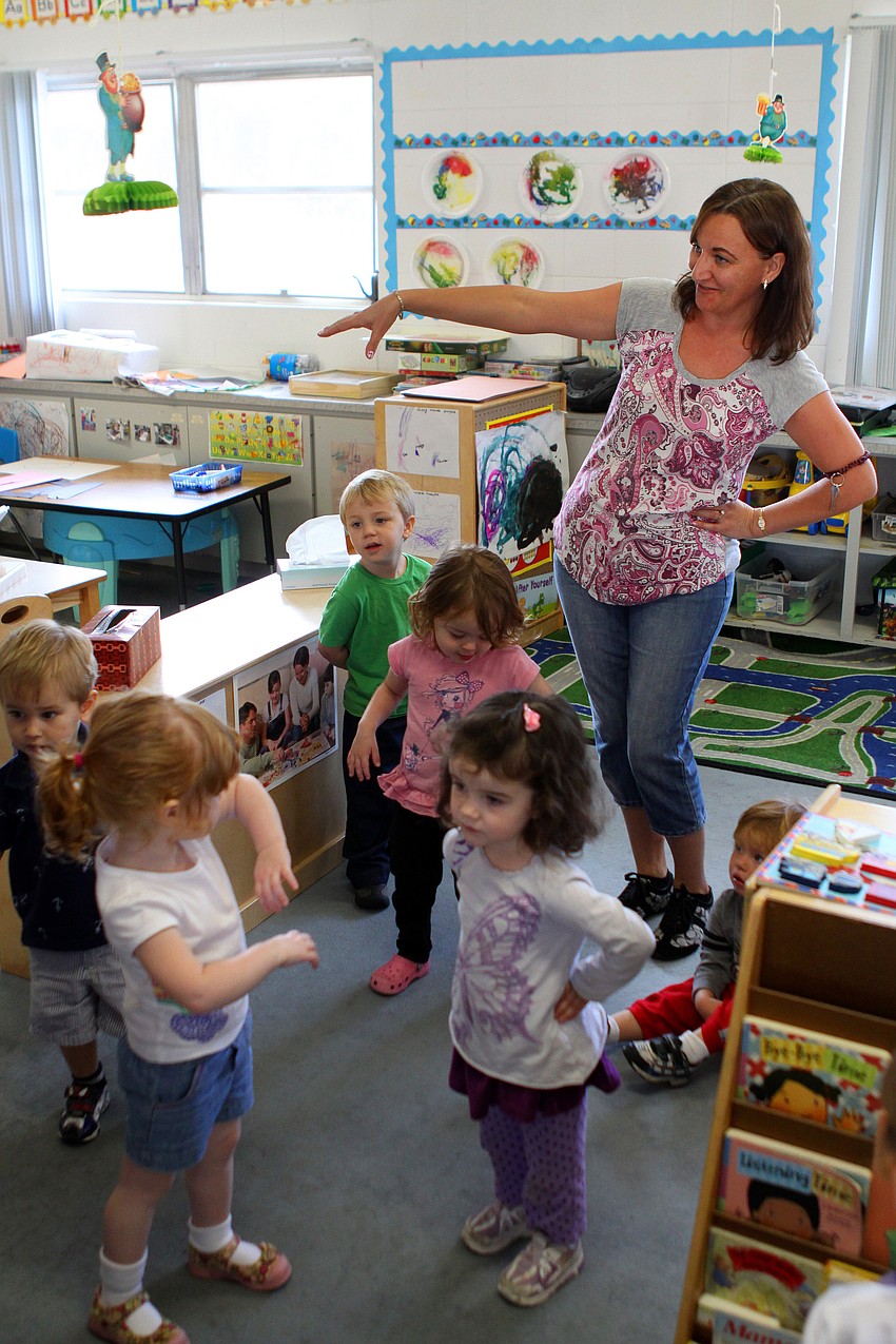 Natalya Fesko and her students do the motions for the song 
