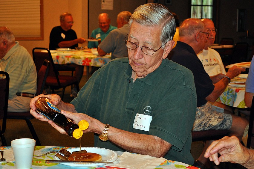 Chuck Roeder puts syrup on his pancake, Tuesday, Feb. 28, during the Siesta Key Chapel Men's Fellowship breakfast in the Fellowship Hall.