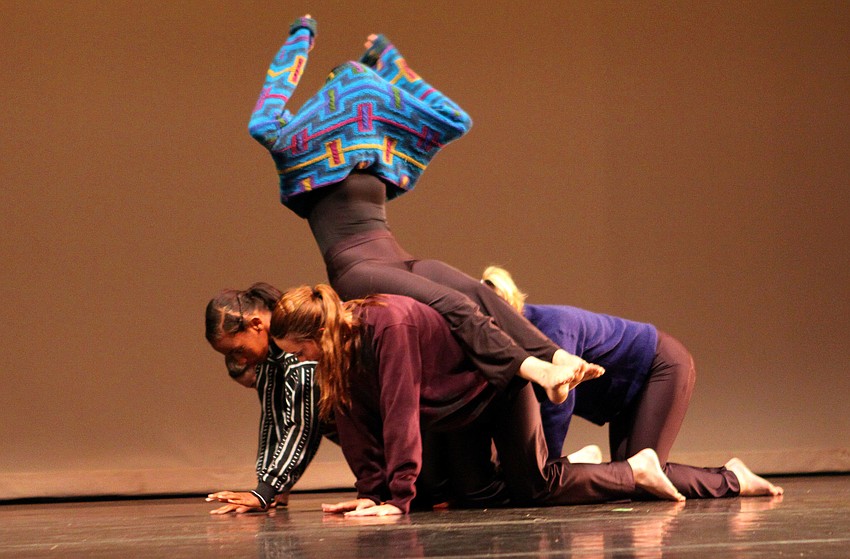 Amanda Stambrosky sits on top of the moving, human bench during the number she choreographed called â€œCozy Things That Cover Your Torsoâ€.