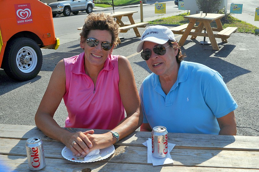 Mary Schiavetta and Jill Friedman hang out at one of the picnic tables.