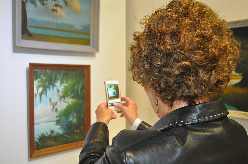 Donna Pearlman captures a lake scene on her iPhone. She has a Highway Man print at home, a field scene by Robert Butler. â€œIt reminds me of a drive to Myakka,â€ she said.