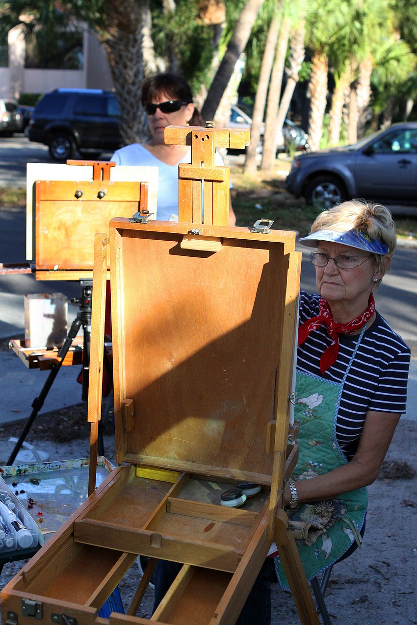 Joan Peters and Heidi Gaudry, two members of the Plein Air Sun Coast group, paint, Thursday, Jan. 12, in Towles Court.