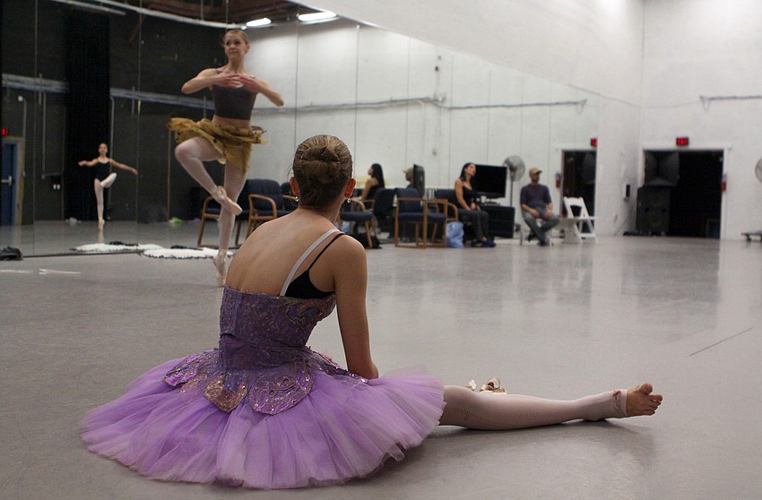 Nikki Jennings, 14, takes a break and sits on the floor in her costume while watching some of the other girls rehearse, Wednesday, Jan. 18, at the Asolo.