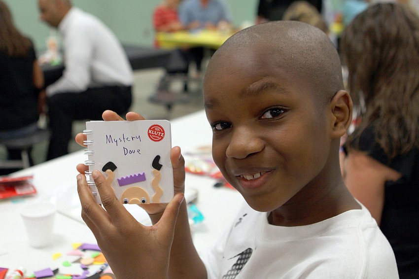 Sayvion Shuler, 10 1/2, with his book, 