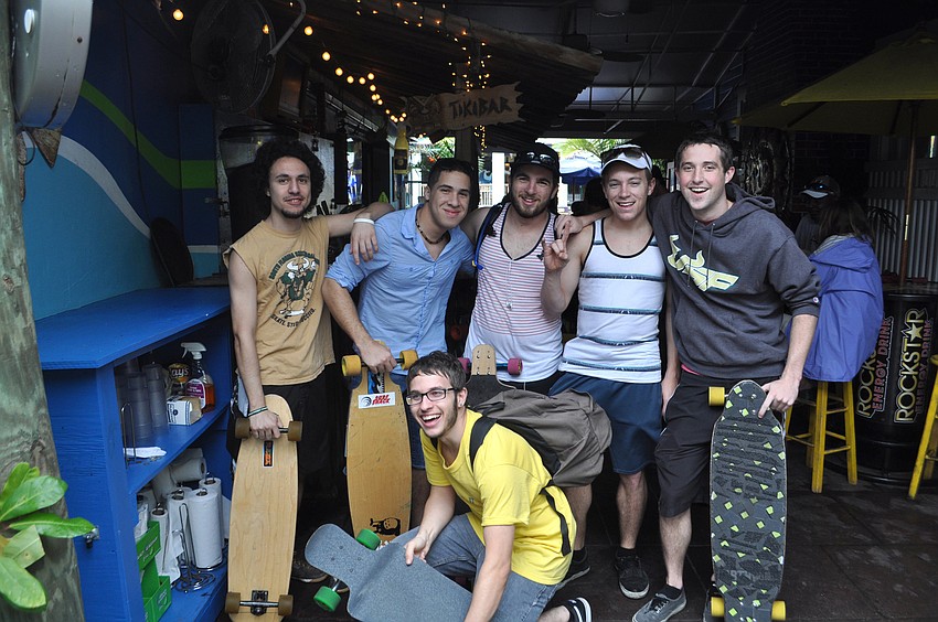 Racers wait for the rain to die out under Gilliganâ€™s roof.