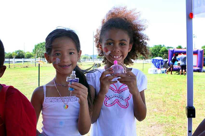 Sophie Hamer, 8, and Alyssa Baker, 6, make sand creations, Saturday, March 24, out at Palmer Ranchâ€™s Springfest.
