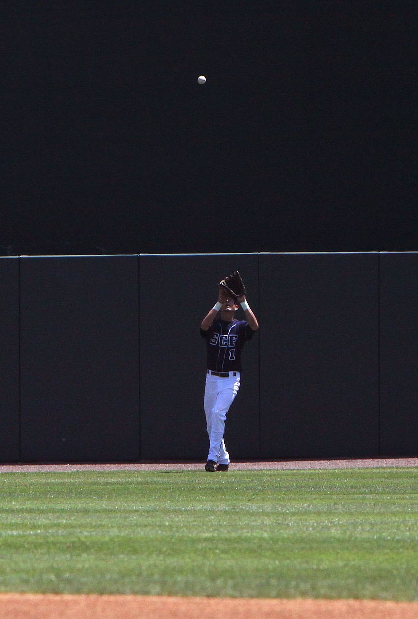 Danny Bodziak catches a fly ball in the outfield.