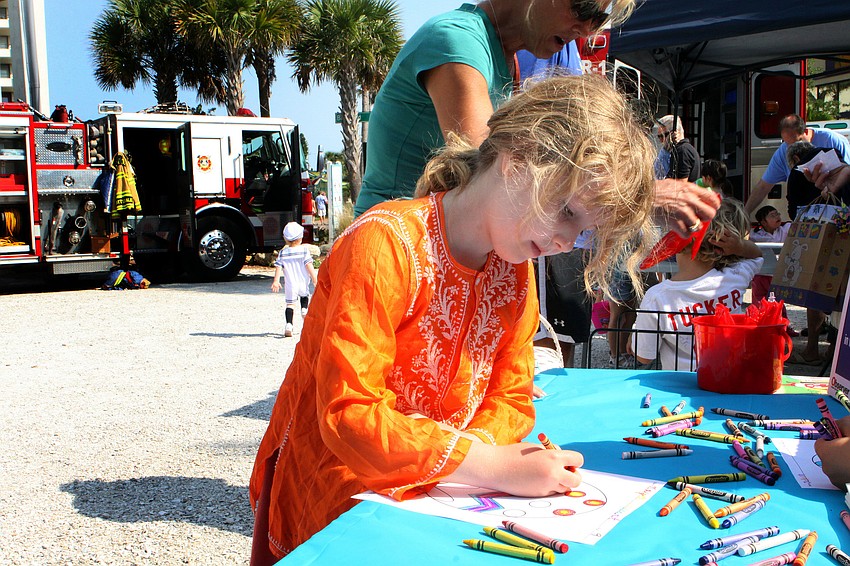 Maya Stewart, 9, colored in a picture of an Easter egg at the Observer and Pelican Press table.