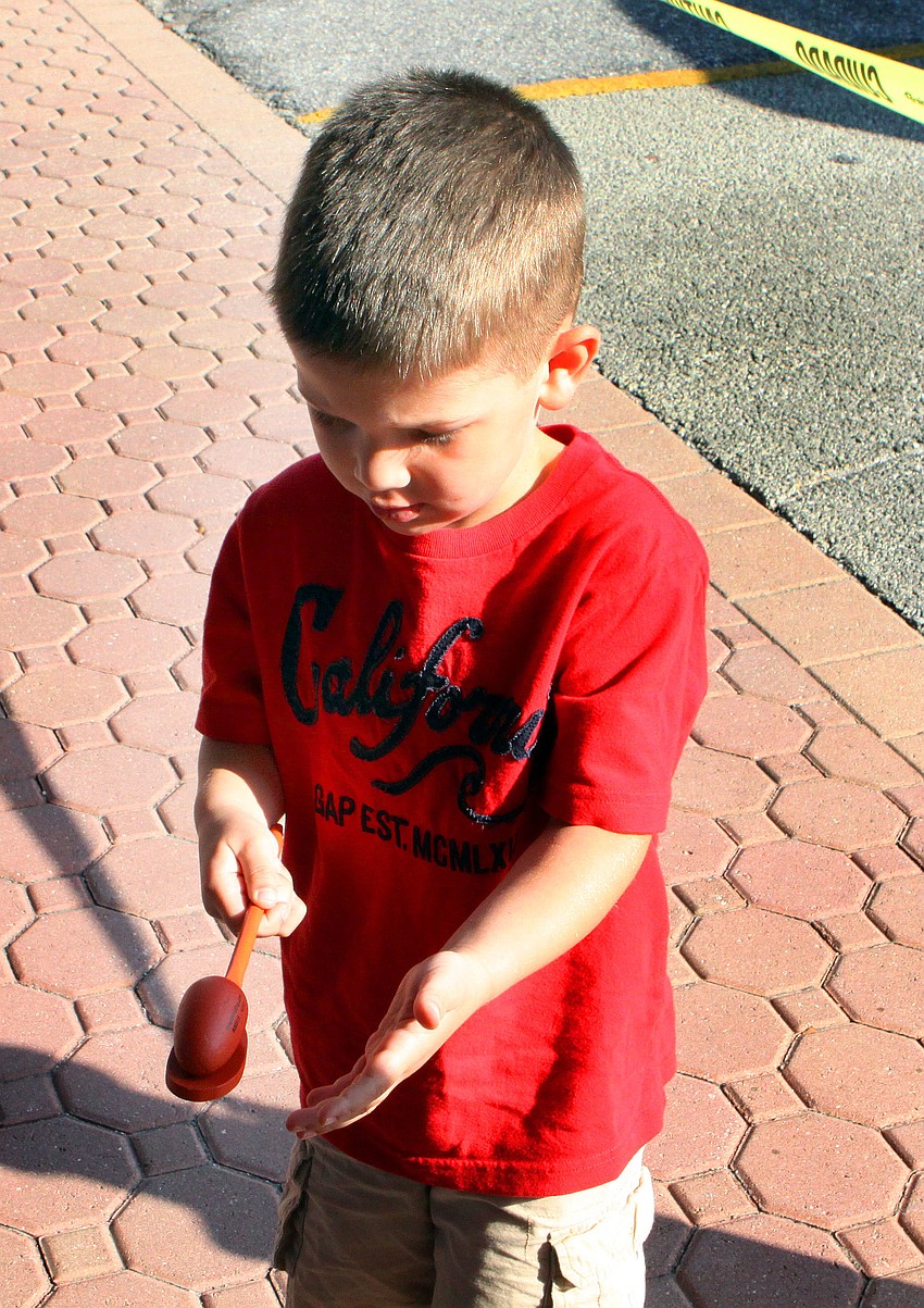 Gavin Wiese, 3 Â½, tries his best to balance a wooden egg on a wooden spoon.