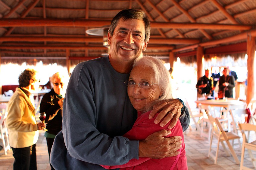 Dave Sparks gets a hug from Glad Elias at his goodbye party, Thursday, Jan. 5, at the Gulf Drive CafÃ©.