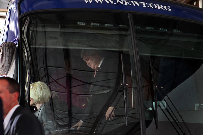 Newt Gingrich makes his way off his tour bus.