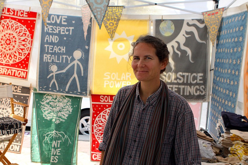 Shawn Robbins of Shorobii poses inside her booth, Saturday, Jan. 28 at the 14th annual Downtown Sarasota Art in the Park at Five Points Park.
