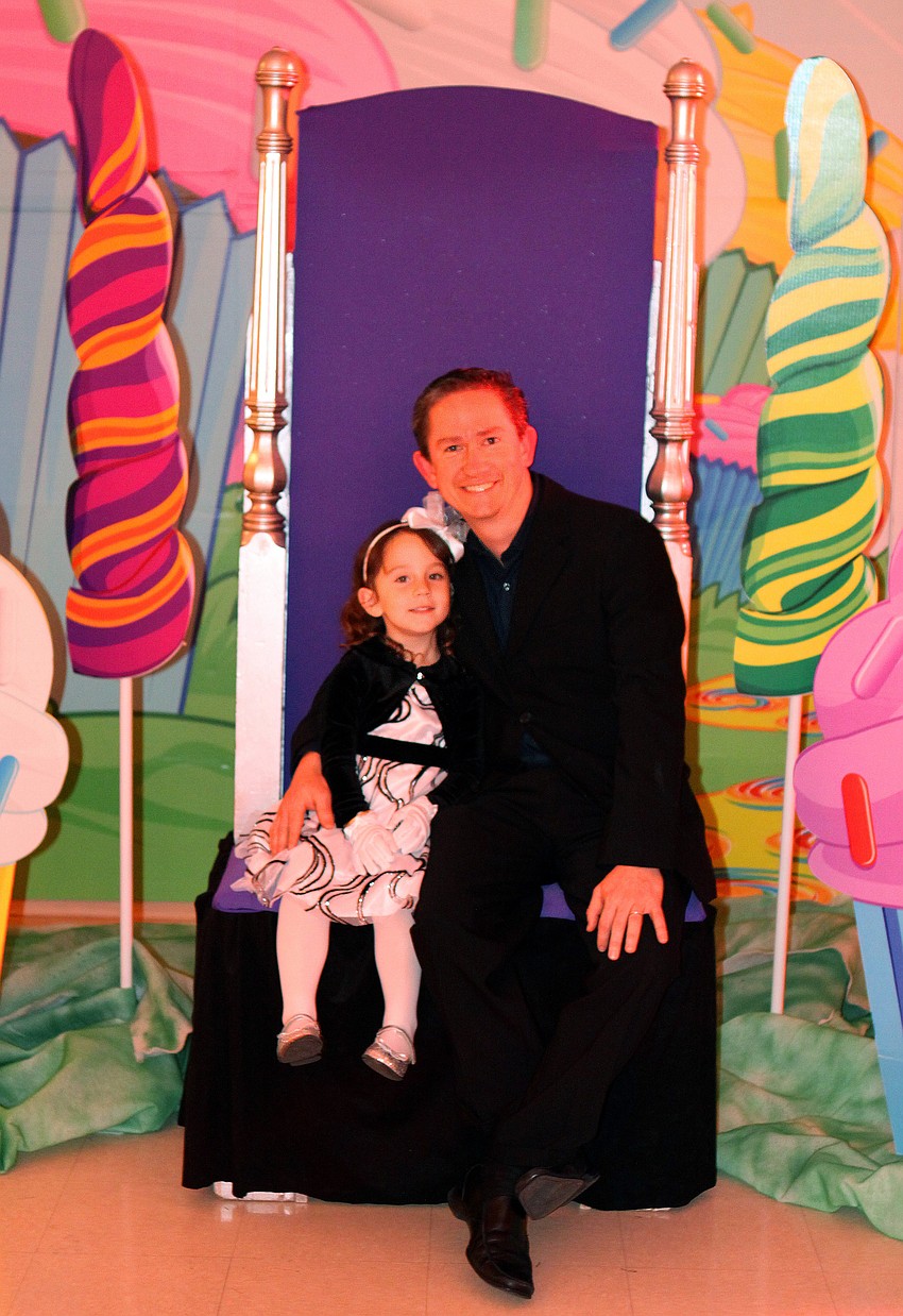 Carleigh, 3, and Michael Morris have their photo taken sitting on a throne at the father-daughter dance, Friday, Feb. 3, at St. Marthaâ€™s.