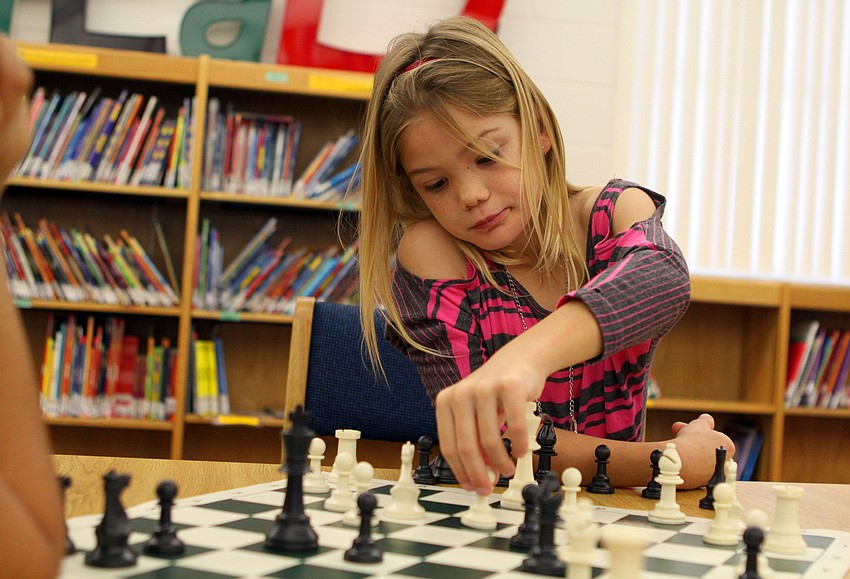 Morgan Smith moves one of her pieces during her game against Vanessa Aparicio.