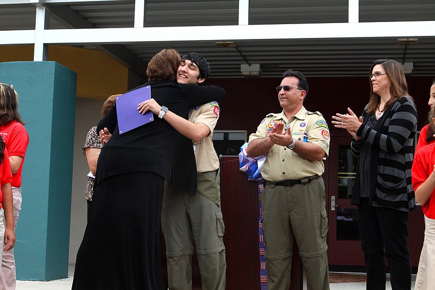 Anthanasios Efthimiades gets a certificate and a hug from Principal Dr. Barbara Shirley, Friday, Feb. 17.