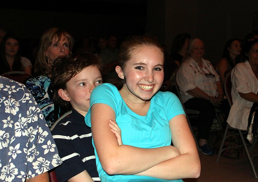Haley Sylvester, 14, â€œhidesâ€ in the audience by sitting on her brother, Jackâ€s, 12, lap in the audience, Friday, March 30.