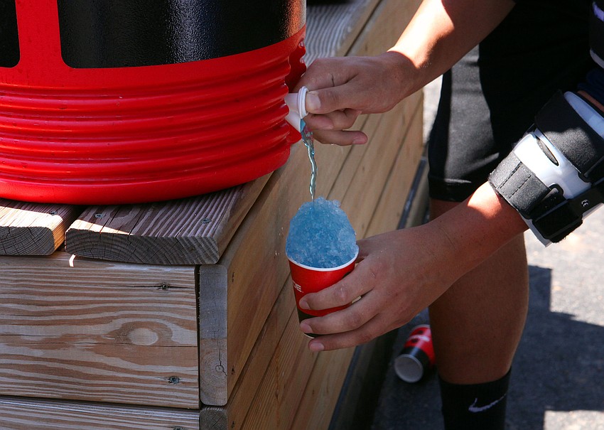 Jeff Dally made his own snow cone using ice and Powerade while watching his teammates in the visitorâ€™s dug out, Tuesday, April 3, at Ed Smith Stadium.