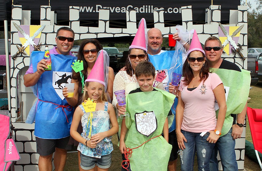 Chris and Andrea Welter, Stephanie and Tim Michel and Scott Johnston stand behind, Peyton Welter, 10, Evan Michel, 10, and Darcy Johnston, Sunday, Jan. 20, during Renaissance Day out at the Sarasota Polo Grounds.