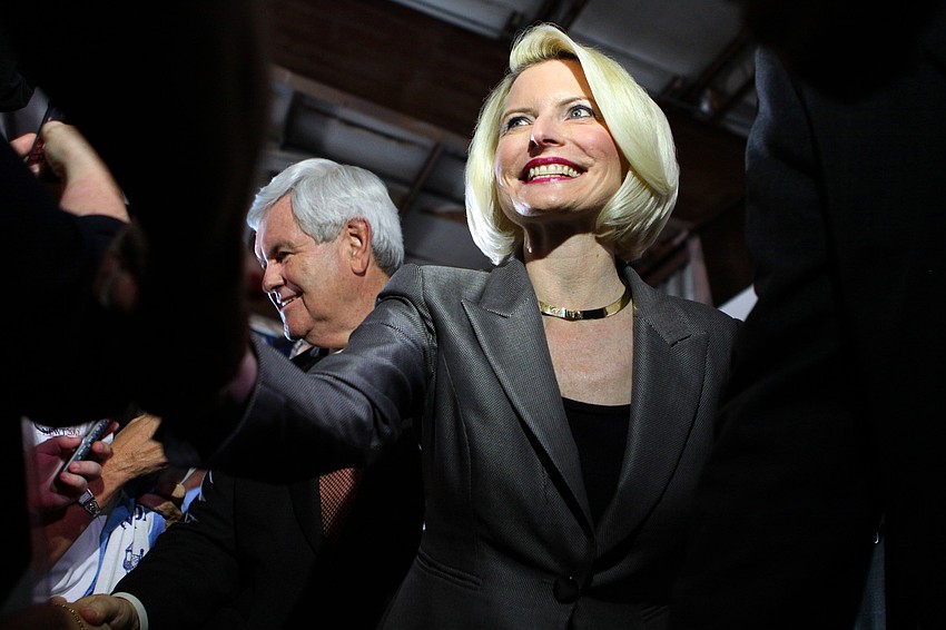 Callista Gingrich gives a big smile as she shakes hands with people in the crowd after she and her husband, Newt Gingrich, arrived at Dolphin Aviation in Sarasota.