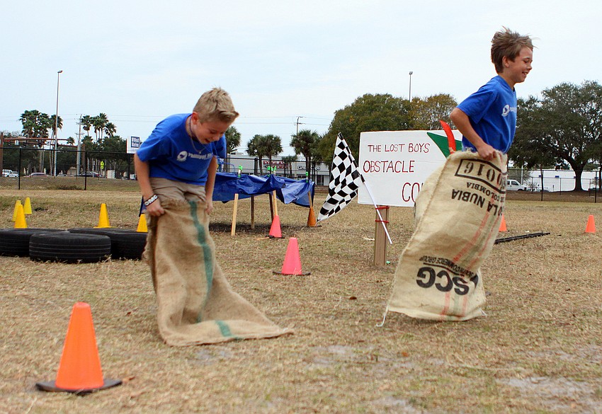 Ben Hawley, 10, and Gage Robbins, 10, have fun racing one another in the Lost Boys Obstacle Course, Friday, Feb. 3, at Phillippi Shores Elementary.