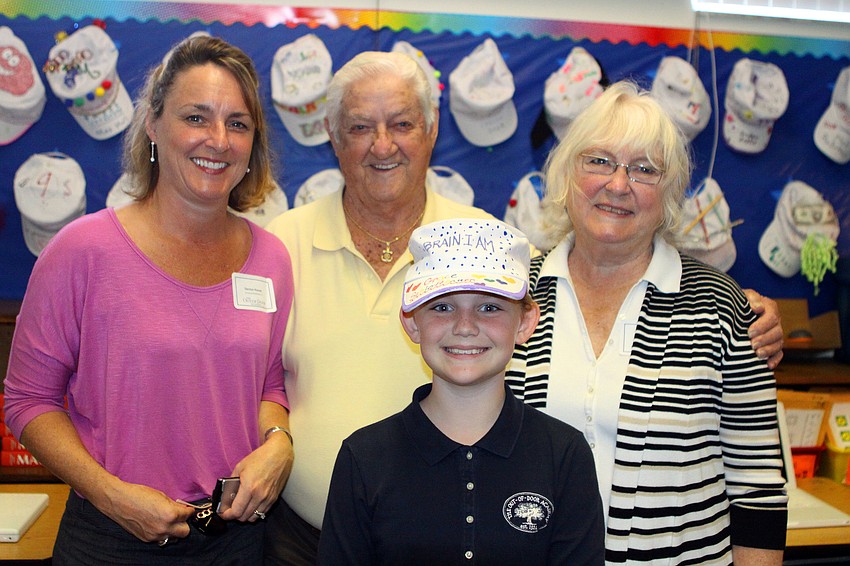 Denise Ronan, Rick Ronan and Pauline Ronan pose with Grace Schlotthauer, 5th grade