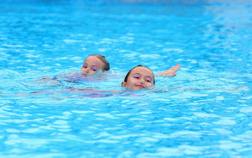 Carmella and Camille Swencki, the youngest members of SASSY, travel in the water during their duet, Sunday, Feb. 19.