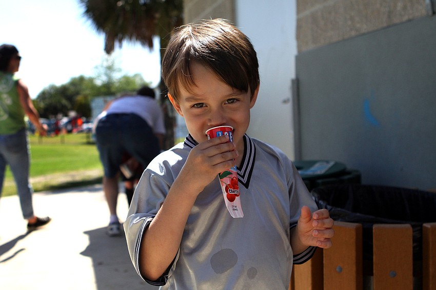 Nico McCurry-Oliver, 4, enjoys an ice pop after playing his soccer game.